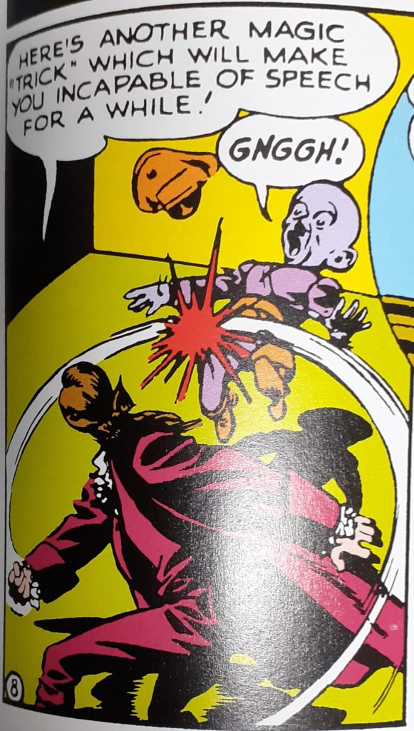 A comic panel with Orson Welles punching a Martian enemy. Welles says: "Here's another magic "trick" which will make you incapable of speech for a while!". "Gnggh!" says the Martian as he's hit.