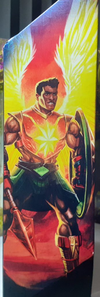 The box art from the side of Sun-Man's box. This has Sun-Man standing and holding his weapon and shield and looking towards the right. The sun design on his chest is a yellow and along with his wings, painted as though they are giving off a bright glow.