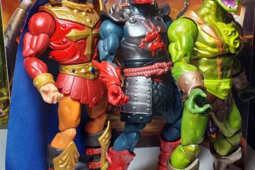 Some figures from the New Eternia sub-line that were release in 2025. From the left there's King Randor with red armour and blue cape, Ninjor in black and red armour and Kobra Khan, a snake man covered in shiny green scales. The figures are posed as though have just done a dance routine.