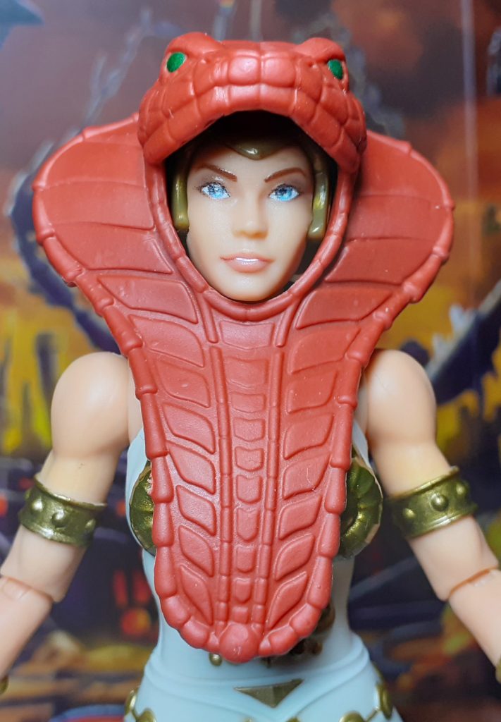 In this photo, the Vintage Collection Teela figure has the snake themed armour on. This is moulded in a reddish brown colour and covers the figure's head and torso.