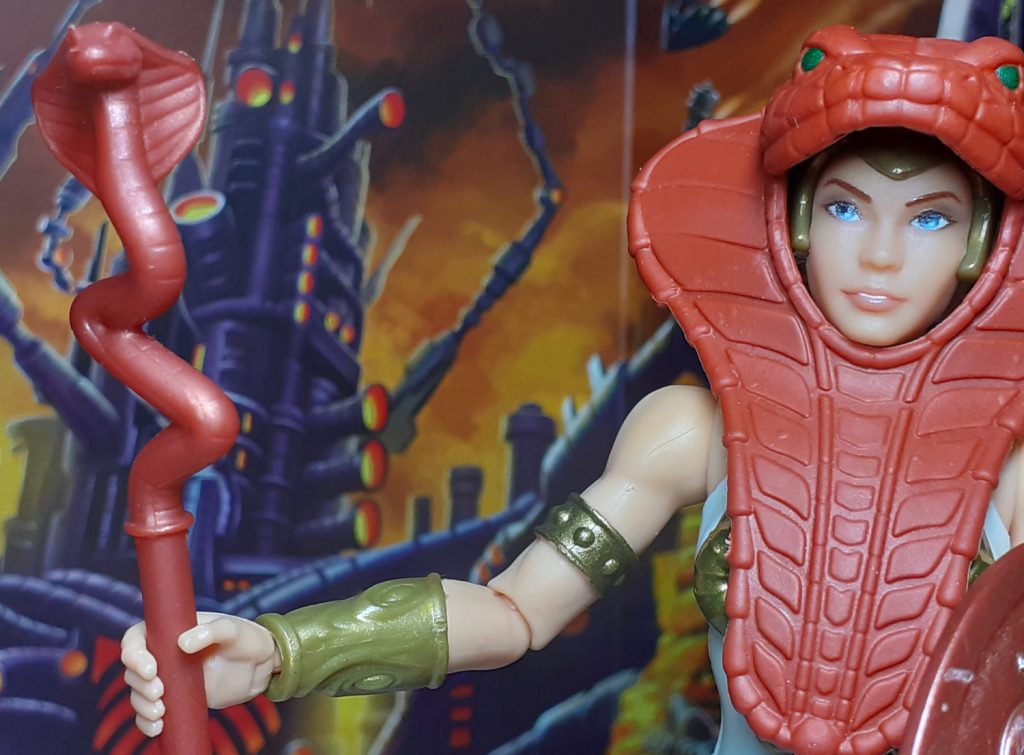 The Vintage Collection Teela figure with the snake armour and holding the snake staff. The staff is once again, reddish brown in colour. The snake head design is much smaller than the New Eternia version but you can still make out the cobra head and hood.