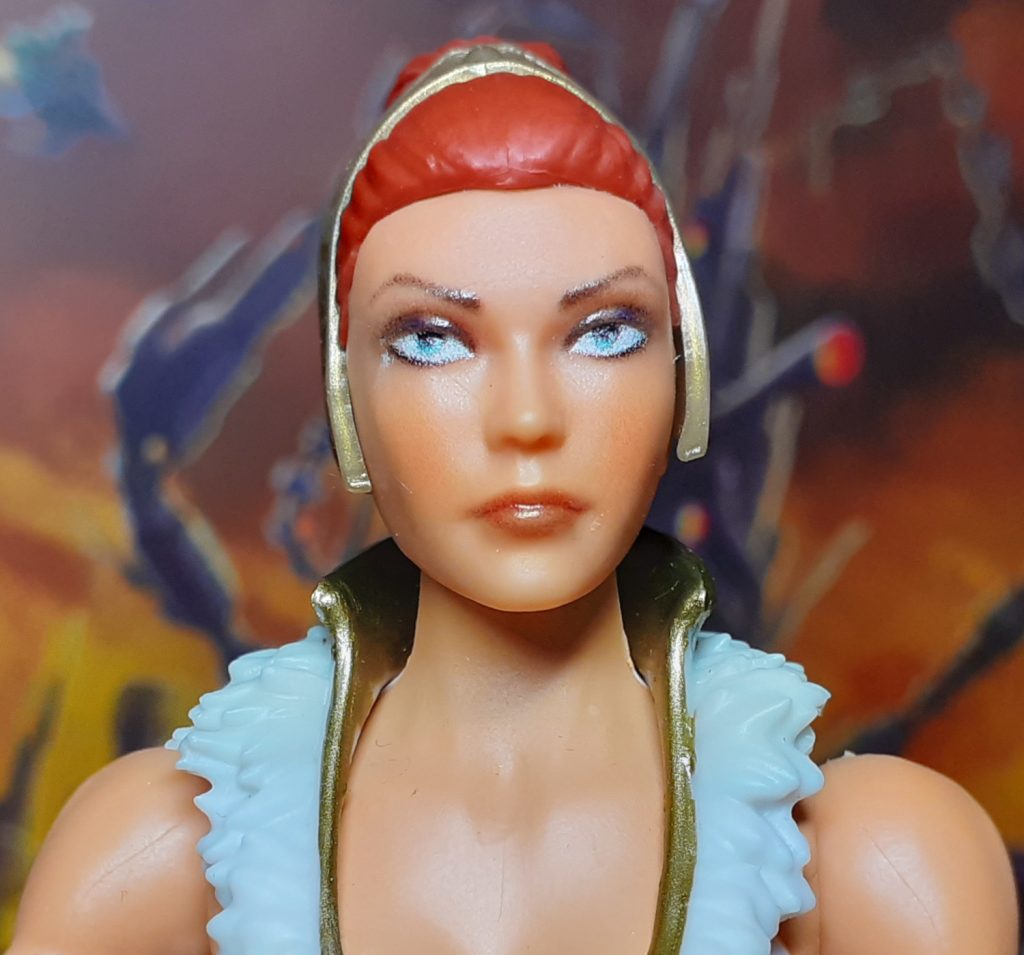 The face and head for New Eternia Teela. This has reddish hair held up and back by a gold tiara.