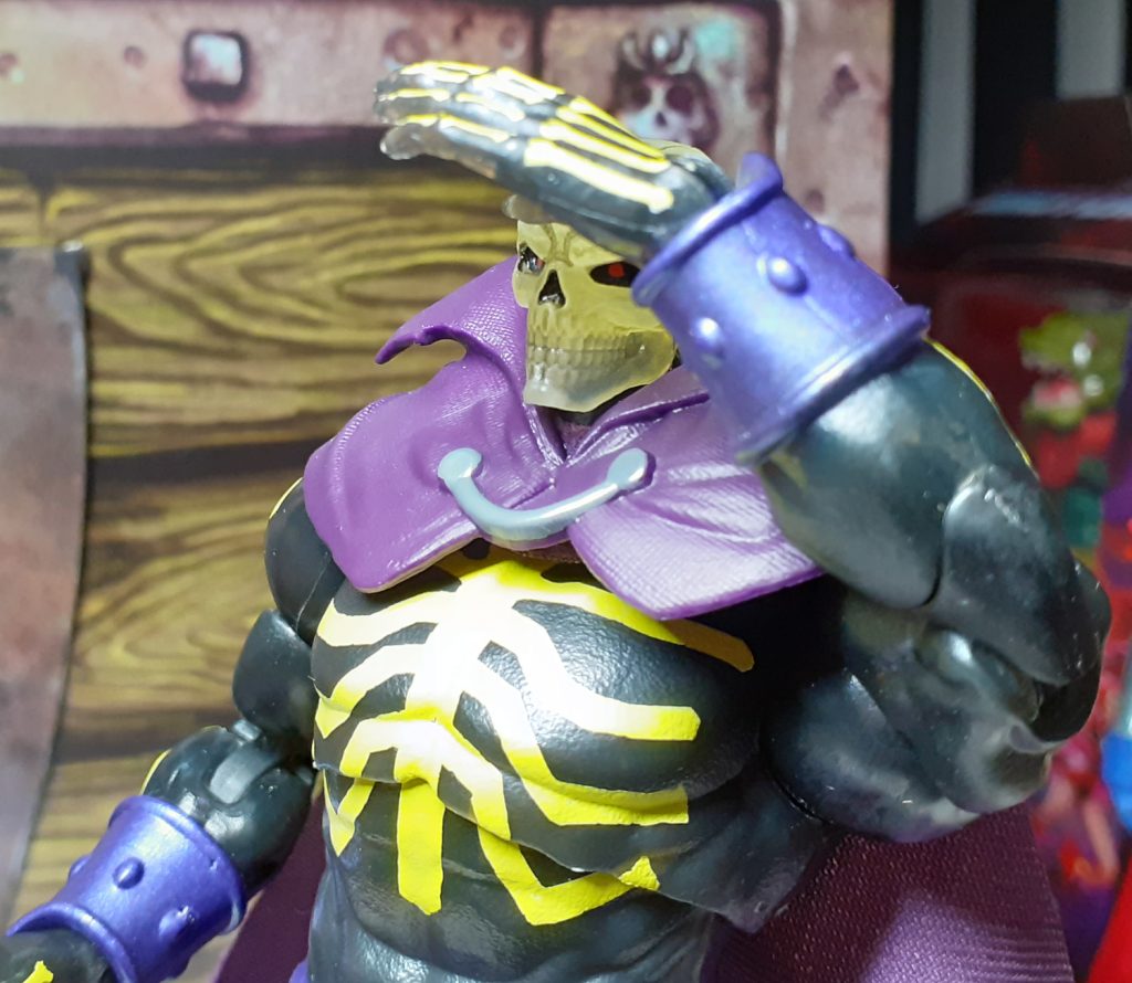 The Revelation Scare Glow figure posed looking over to the viewer's left. Its left open hand is posed over its eyes and shading them as though the figure is looking for something in the distance.