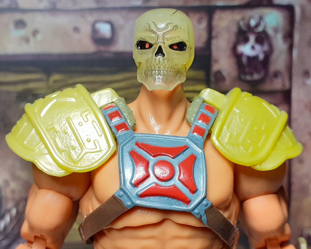 A photo of Scare Glow's skull head on the Viking He-Man figure. Only the upper torso and shoulders of the figure can be seen but it's clear that the head of Scare Glow is too small!