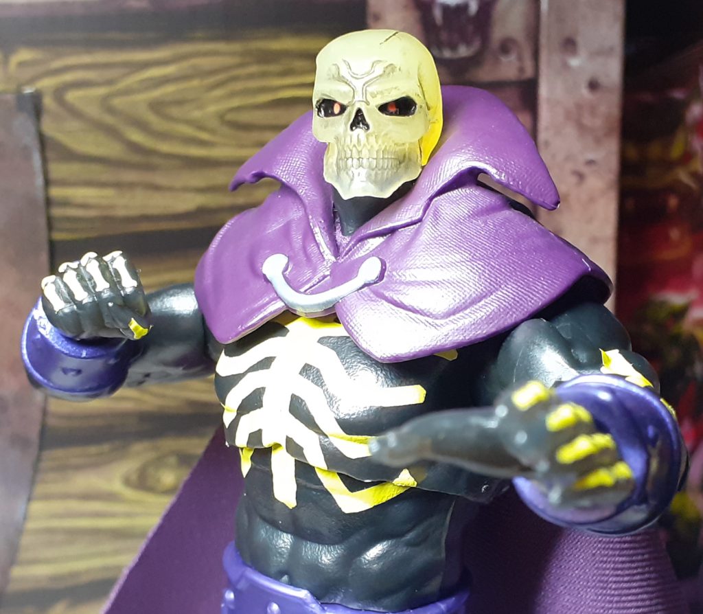 Scare Glow with the fist and flat open hand posed in an action stance.