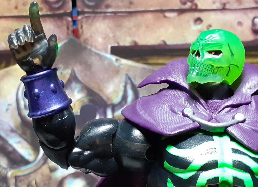 The plastic this Scare Glow is made from is a slightly translucent smokey black. It's most easily seen in the hands as here with the figure holding up one of it's hands in the air. The background can just about be seen through the plastic.