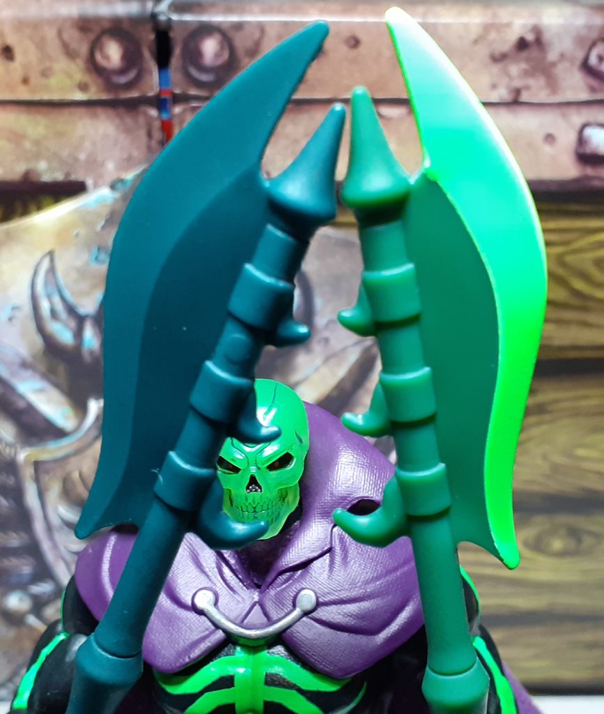 The SDCC version of Scare Glow holding up both versions of the halberd. On the left is the plainer, dark green halberd of the standard retail release. On the right is the SDCC version which is a lighter green and has some of the day glow green painted on the blade's edge.