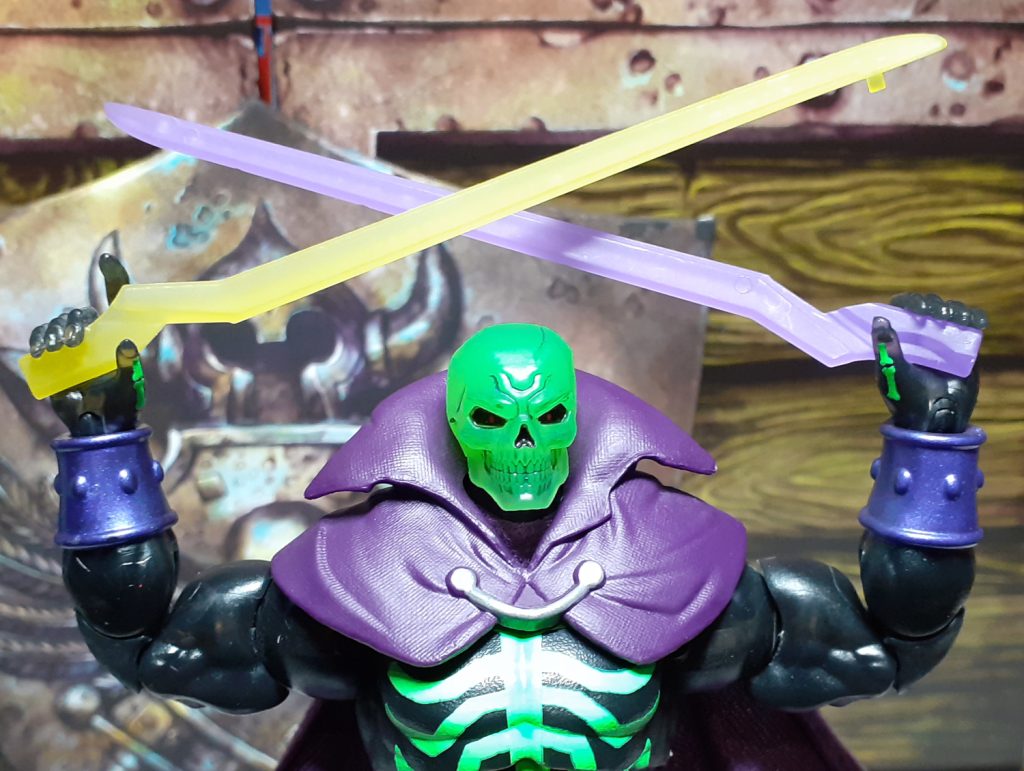 The Scare Glow figure holding the two halves of the Sword of Power so that the two blade halves form a cross over its head.