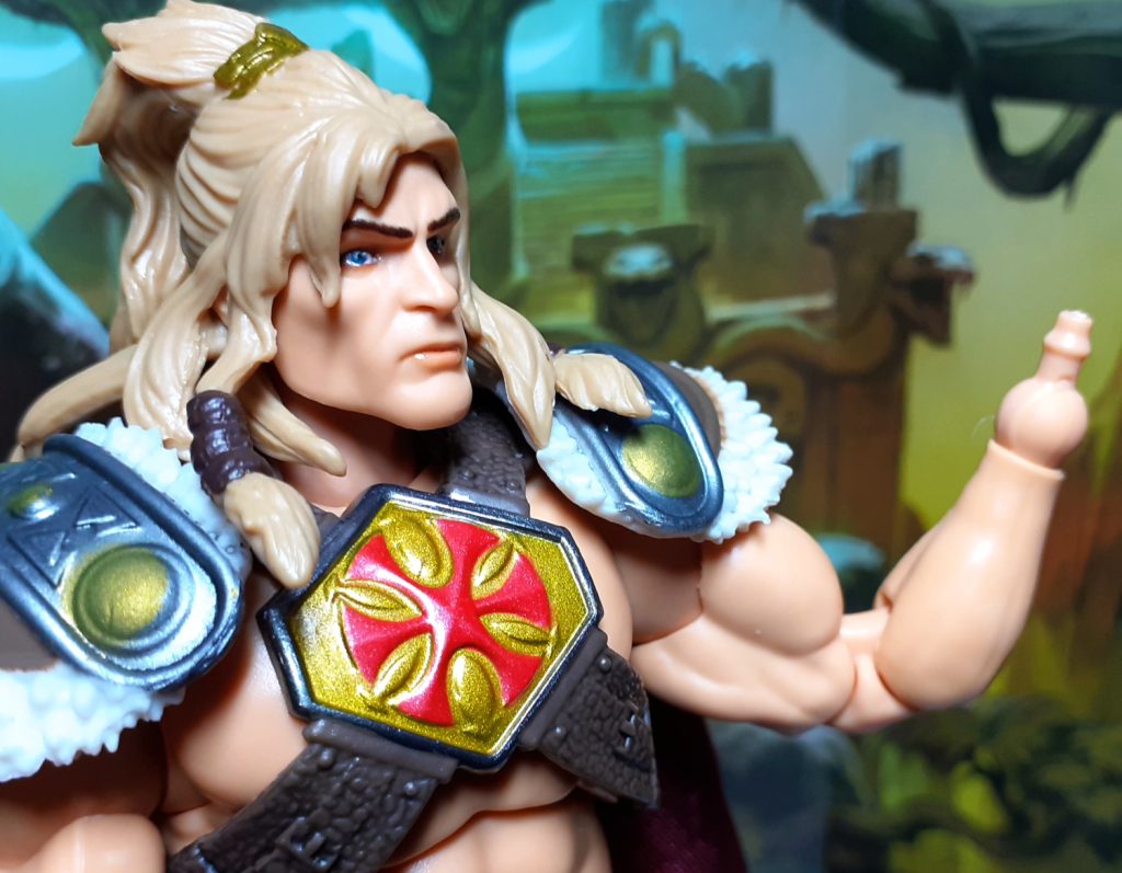 The King Grayskull figure holding up its left wrist minus its hand. This shows the peg that fits into a slot in the hands.