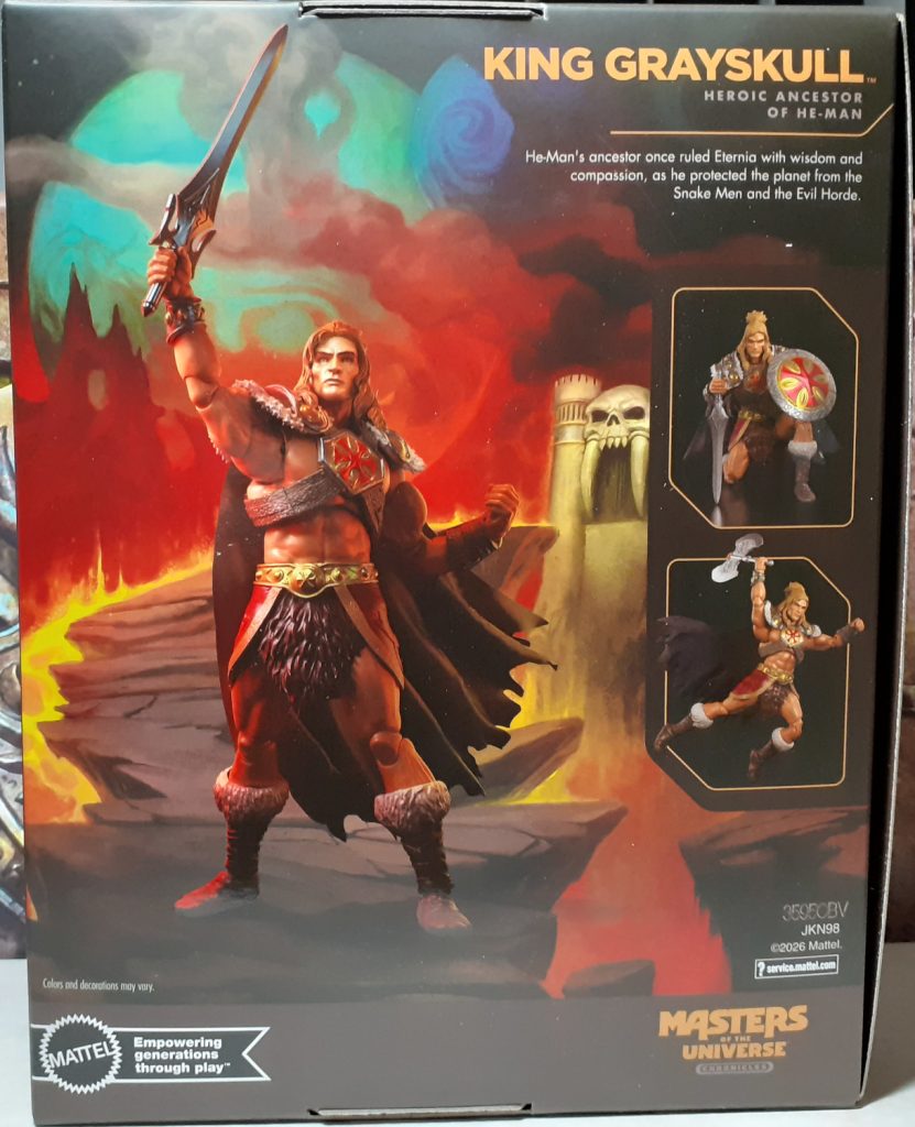 The back of the box has a photo of the figure holding the Sword aloft in its right hand. The figure is on a painted background of a jagged and rocky path leading to Castle Grayskull in the background. On the right hand side are a couple of photo inserts showing the figure in some different poses.