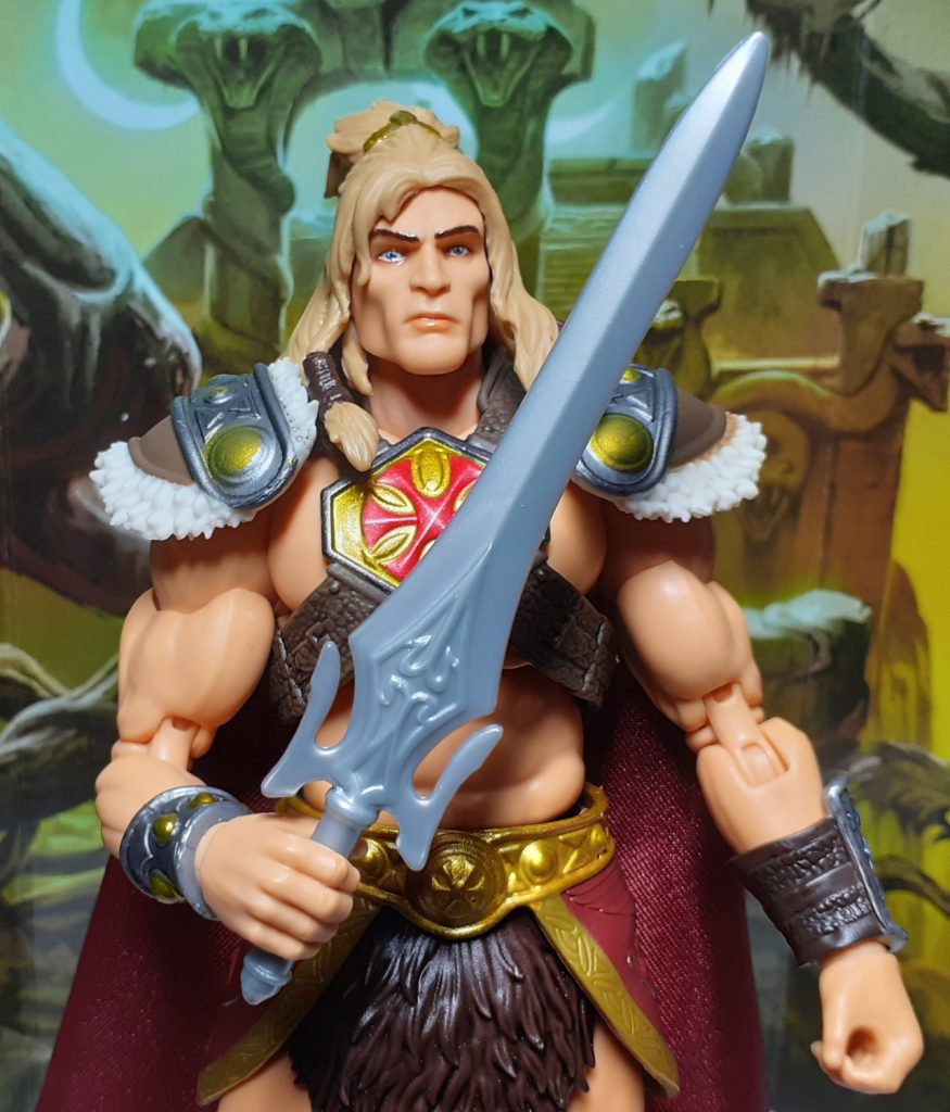 A photo of the King Grayskull figure holding the Sword of Power in its right hand. The Sword is moulded from a plain, slightly shiny grey plastic. The figure is holding the Sword at roughly waist level with the blade going upwards.