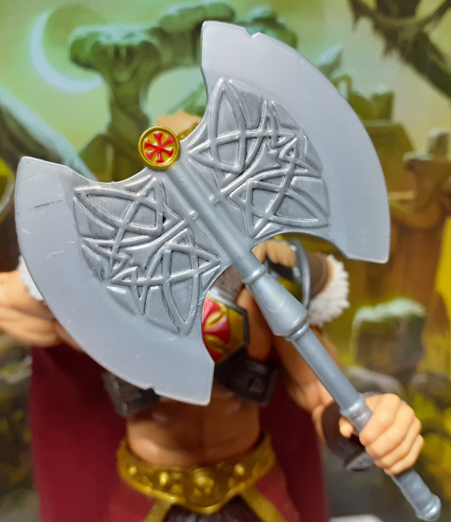 A close up look at the design of the battle axe. The axe has two large blades with a central design that features Celtic-style knot work.