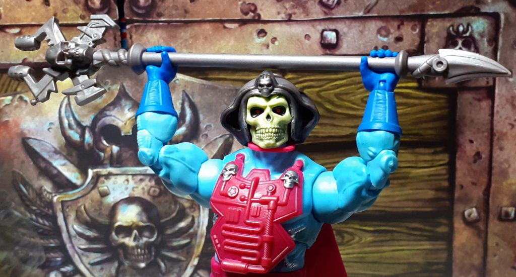 The Skeletor figure holding the Havoc Staff up over its head using both hands.