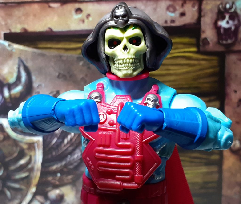 The Skeletor figure holding its fists close together in front of its chest whilst looking straight at the viewer.