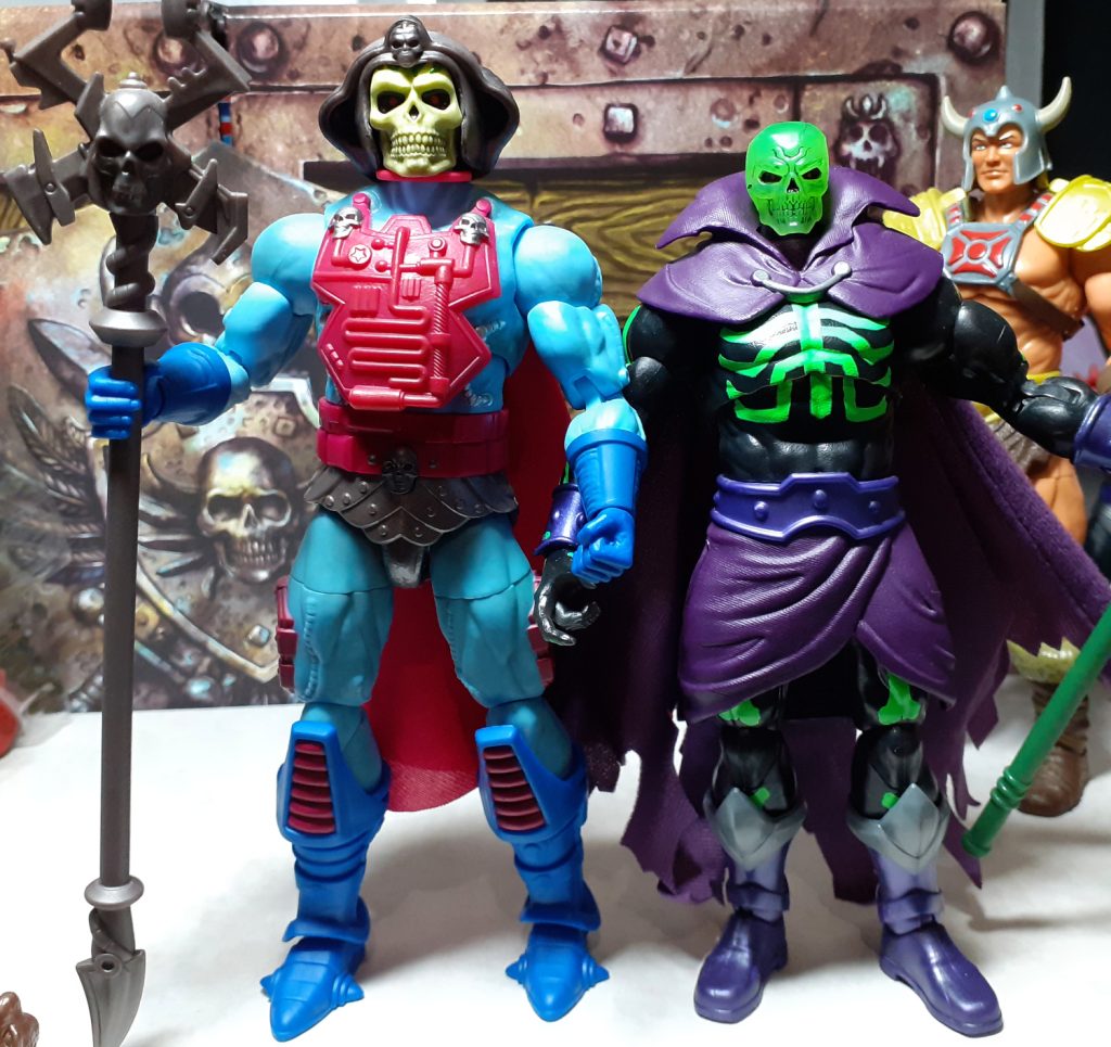 In this photo, New Adventures Skeletor figure is on the left and standing alongside it on the right is the Revelation Scare Glow figure. The Skeletor figure towers over the Scare Glow figure.