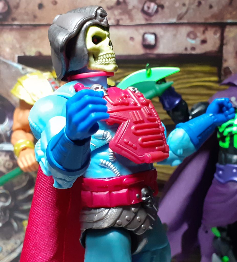 In this photo, the New Adventures Skeletor figure has been bent backwards at the mid-torso. This shows the articulation of the figure isn't hindered by the large piece of magenta coloured armour mounted on the front of the chest.