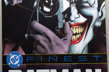 The front cover to the book DC Finest Batman: The Killing Joke and Other Stories. The cover art is the Joker holding up a camera and taking a picture.