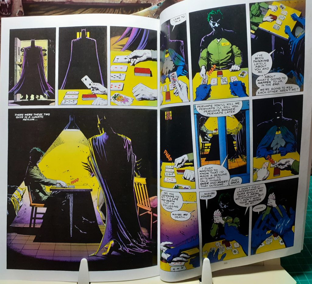 Two interior pages from the DC Finest Batman The Killing Joke and Other Stories book. These pages are from the Killing Joke story itself. They show the Batman entering a prison cell and sitting down at a table opposite from the Joker. The Joker appears to be playing a game of cards.